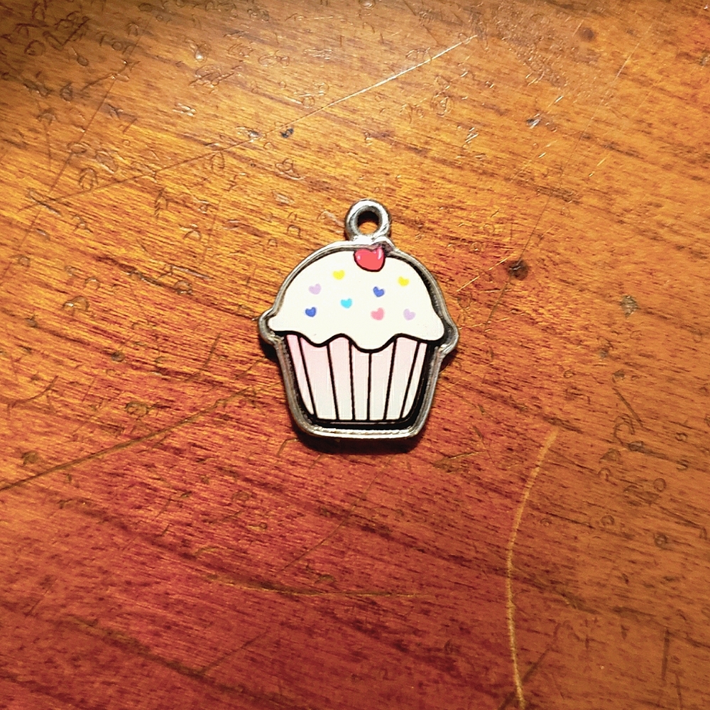 Enamel cartoon cupcake charm.